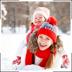 mom and kiddo playing in the snow