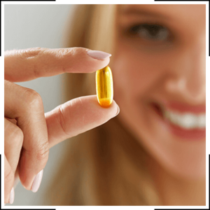 woman holding a vitamin supplement
