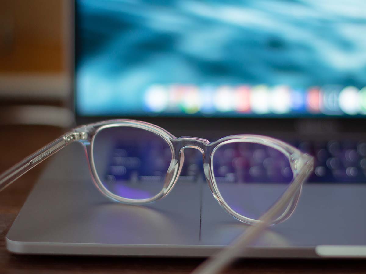 blue light glasses next to computer screen