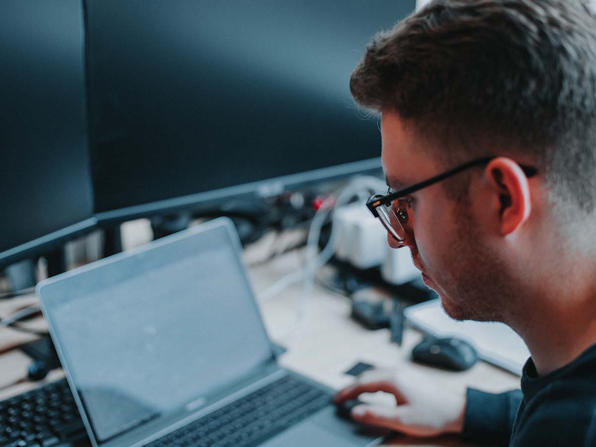 man working on computer at night