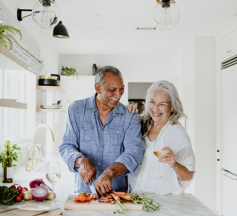 Elderly couple cooking in a kitchen